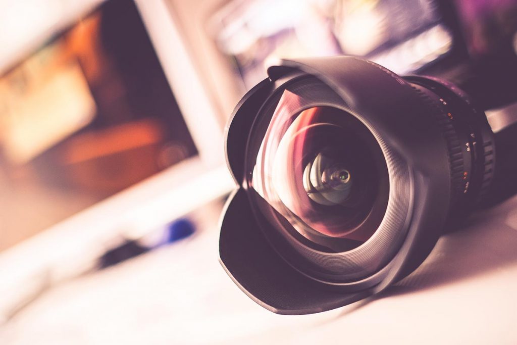 An image of a professional camera lens on a table, ready for capturing high-quality photos.