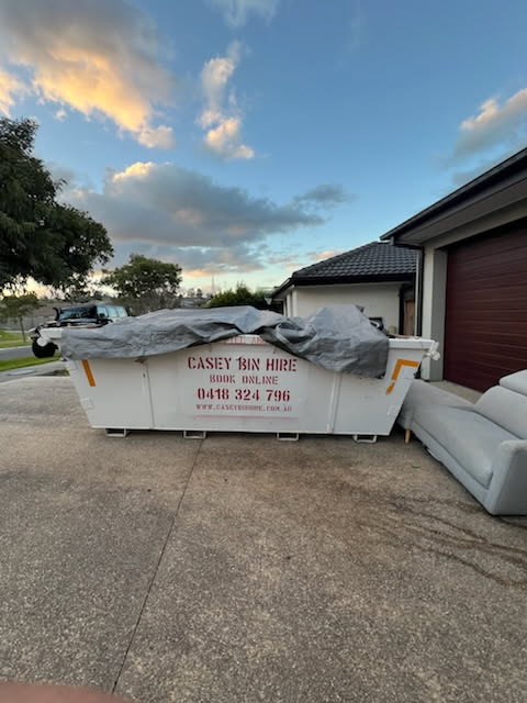 Large skip bin for waste collection outside a residential property in Casey.