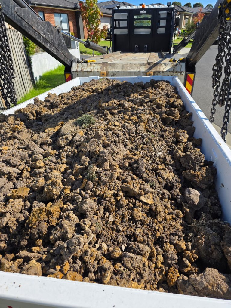 Heavy soil and debris in a skip bin for local Casey skip bin hire services.